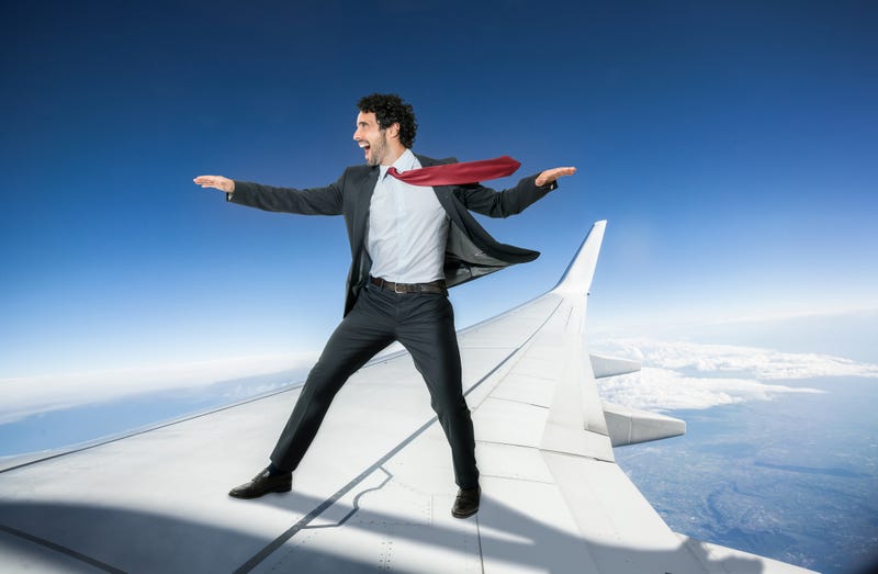 Man on plane wing stock photo. 