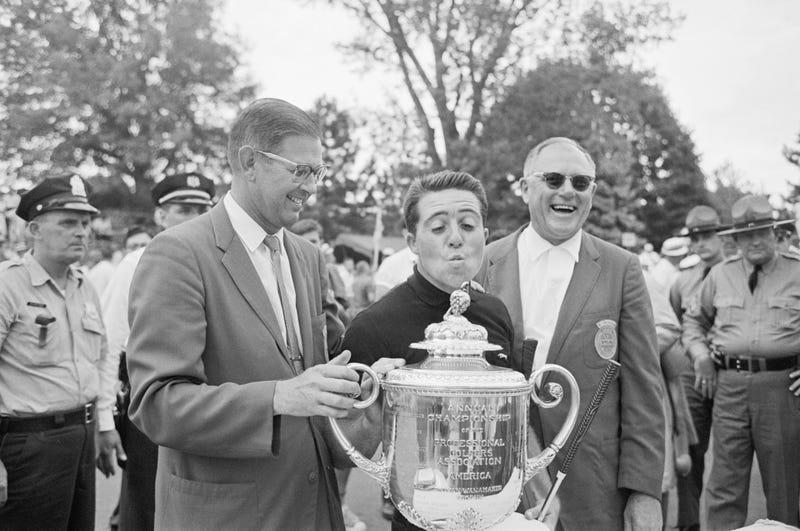 Gary Player clowns as he's asked to "kiss the trophy" after winning the PGA Championship at Aronimink Golf Club in 1962.