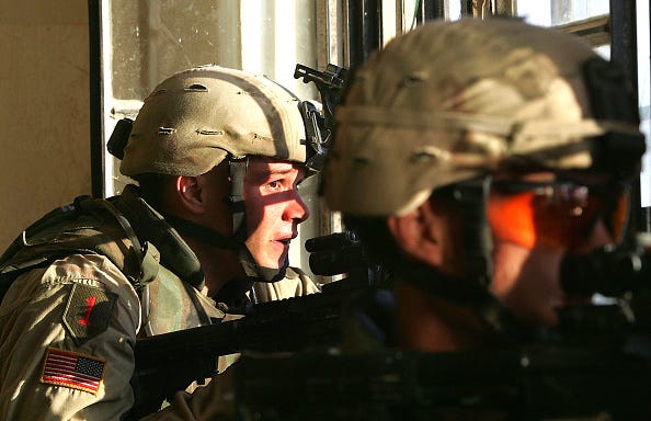 U.S. Army soldiers from the 1st Infantry Division's 2nd Battalion-2nd Regiment engage enemy forces in heavy fighting November 9, 2004 in the insurgent stronghold of Fallujah, Iraq