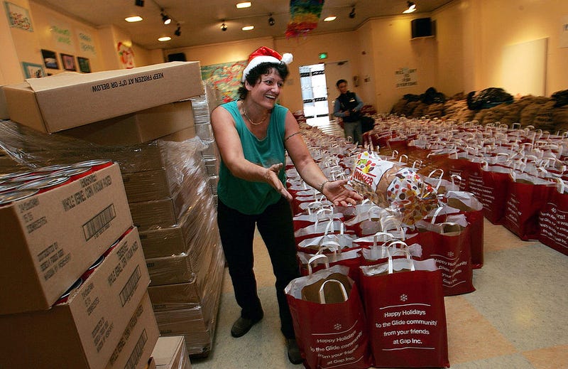 A volunteer tosses a loaf of bread that will be put into grocery bags to be distributed to the needy at Glide Memorial Church December 16, 2004 in San Francisco.