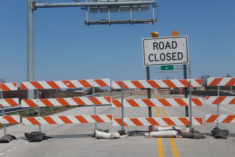 Road Closed barricades for through traffic over bridge.