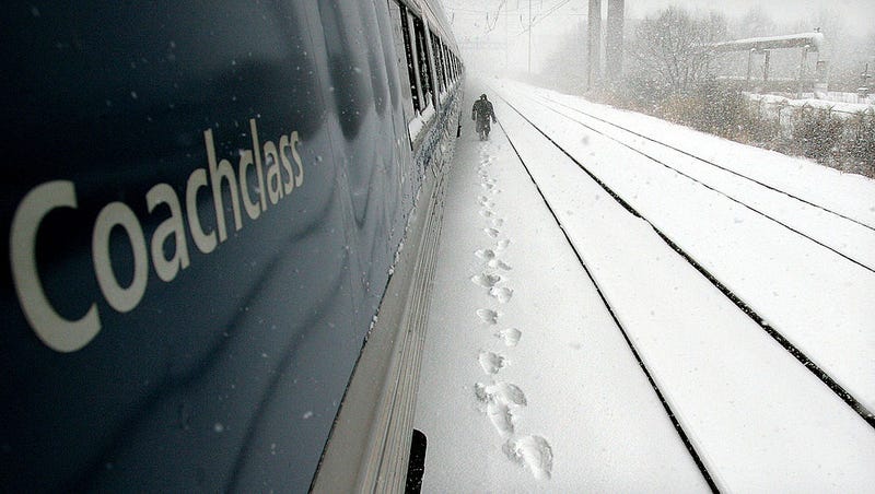 An Amtrak worker walks along the tracks checking for debris beneath the train after it stopped January 22, 2005 near Wilmington, Delaware. 