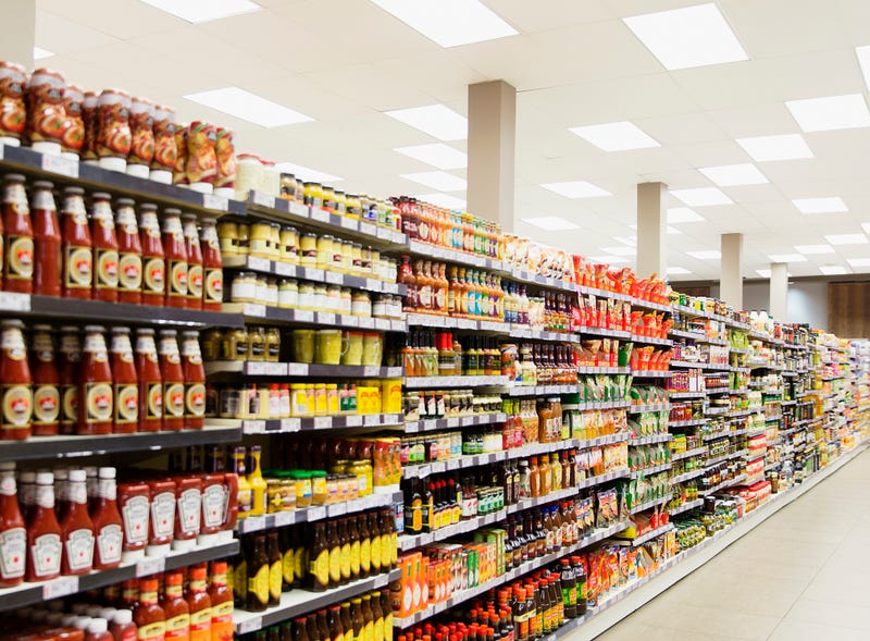 Condiments on a grocery store shelf. 