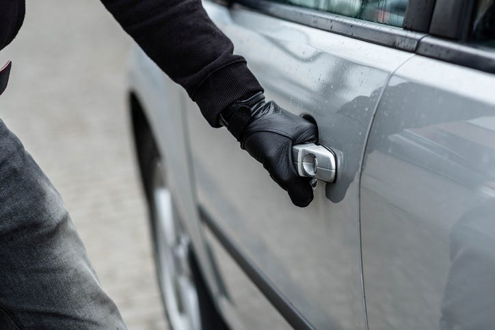 Thief stealing a car. 