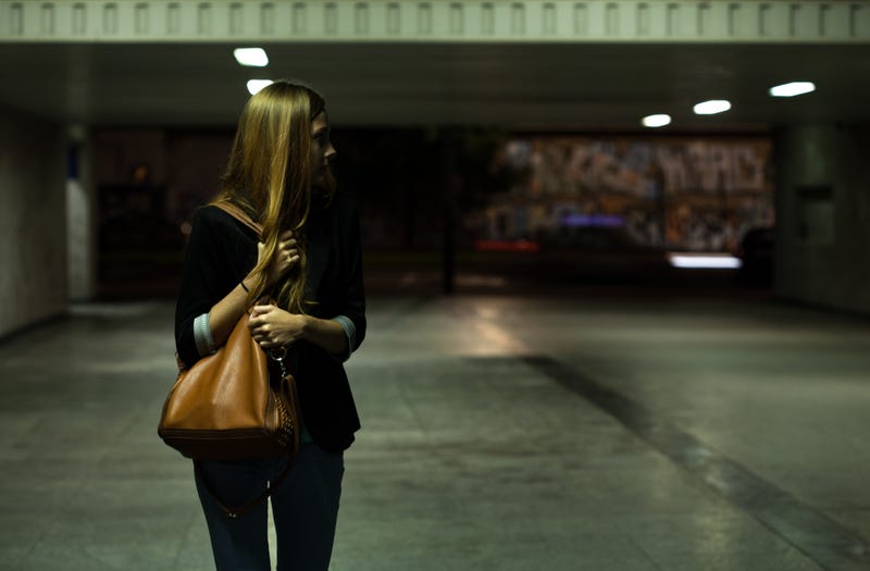 woman clutching purse in parking garage