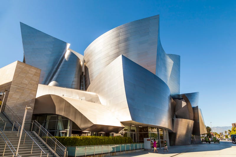 silver building with people entering from the bottom