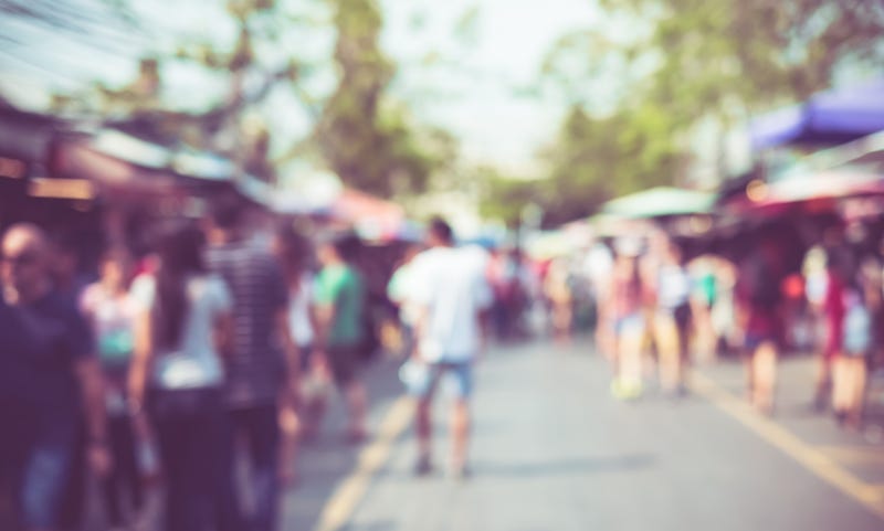 Blurred background : people shopping at market fair in sunny day, blur background with bokeh.