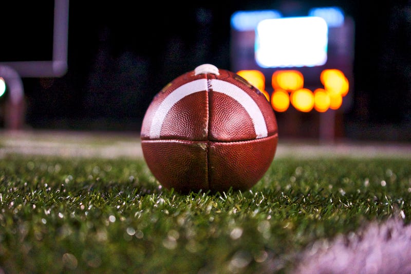 Football on a field at night