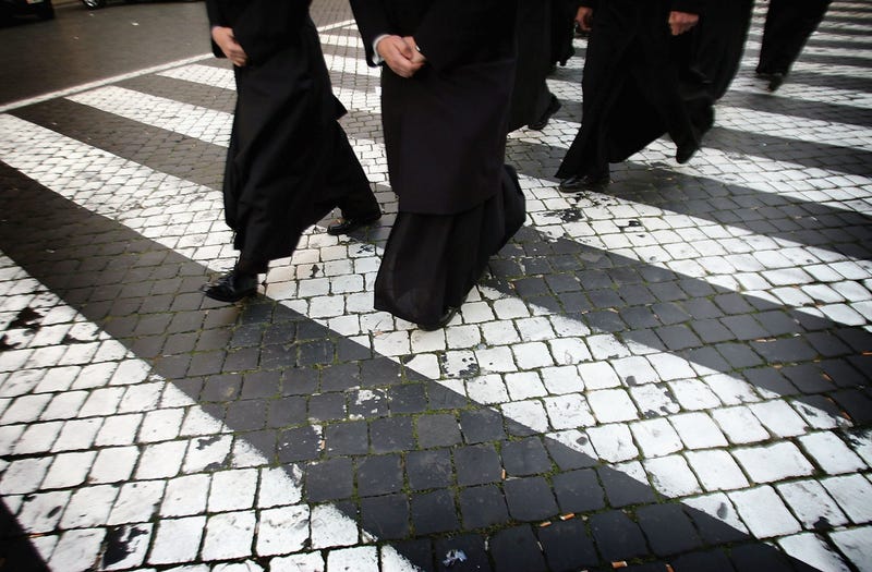 People make their way to a funeral