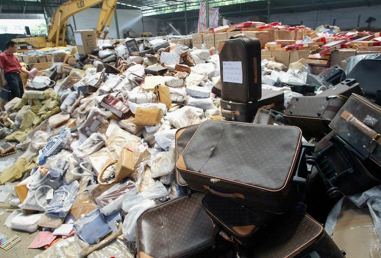 Pile of counterfeit suitcases, luxury items