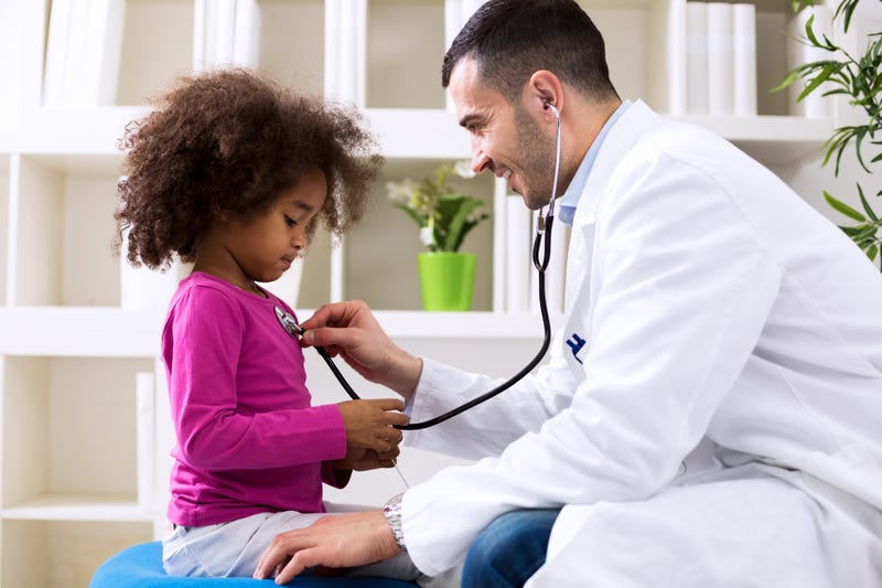 children's doctor meets with young girl