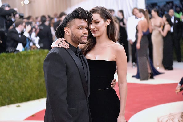 The Weeknd and Bella Hadid attend a red carpet event. 