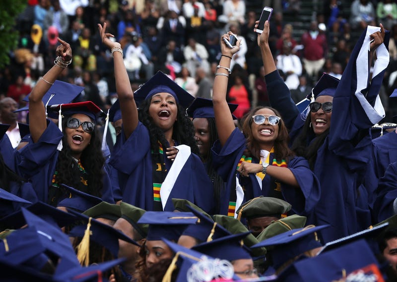 Graduates celebrate at a Howard University commencement ceremony.