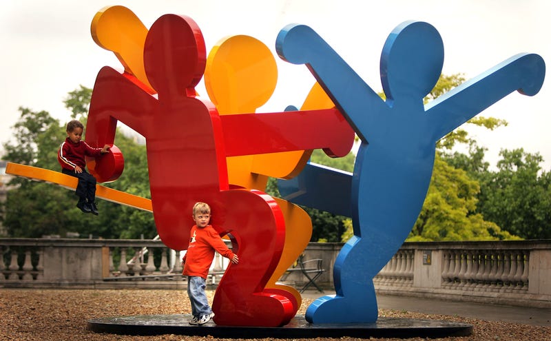 Children play on a giant sculpture by Keith Haring in Somerset Housen on June 2, 2005, in London.