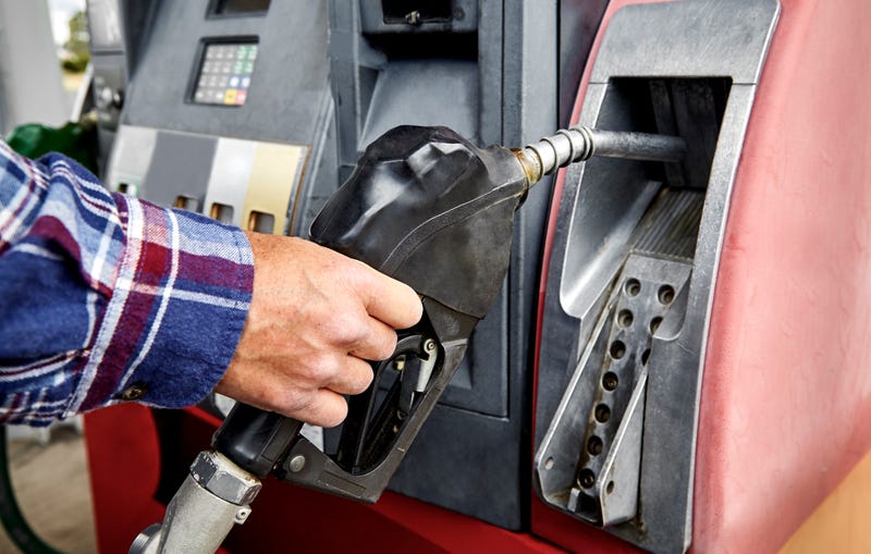 Hand grabbing gas pump. 