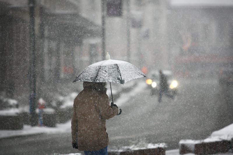 Man with umbrella during snow storm
