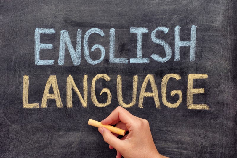 Hand drawing English Language on blackboard. Close up.