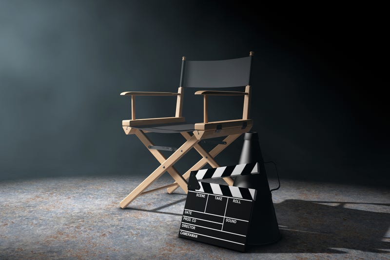 Director Chair, Movie Clapper and Megaphone in the volumetric light on a black background.