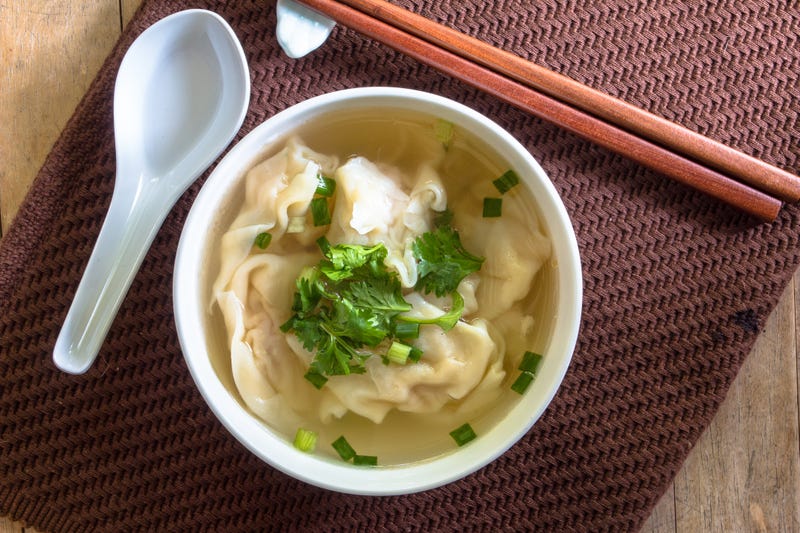 Wonton shrimp dumpling in clear soup with chopsticksWonton shrimp dumpling in clear soup with chopsticks