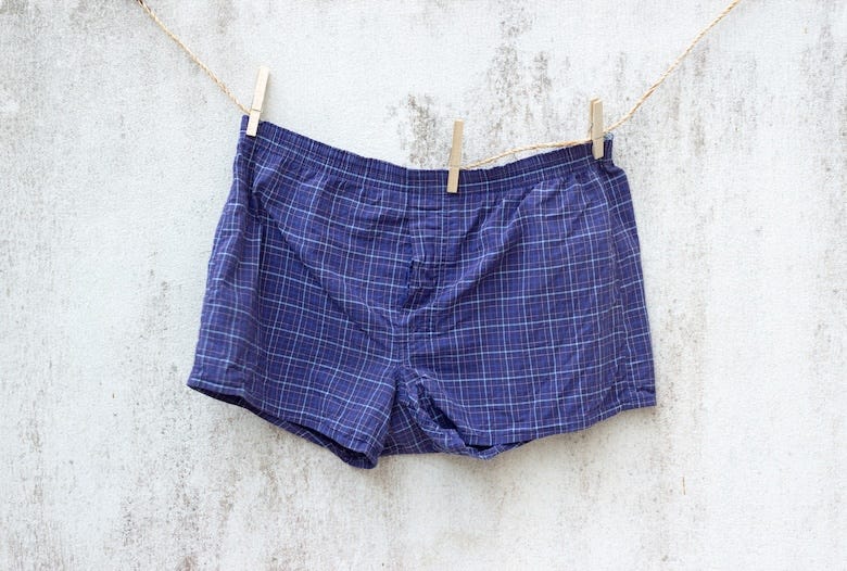 Blue boxer underwear on grunge wall