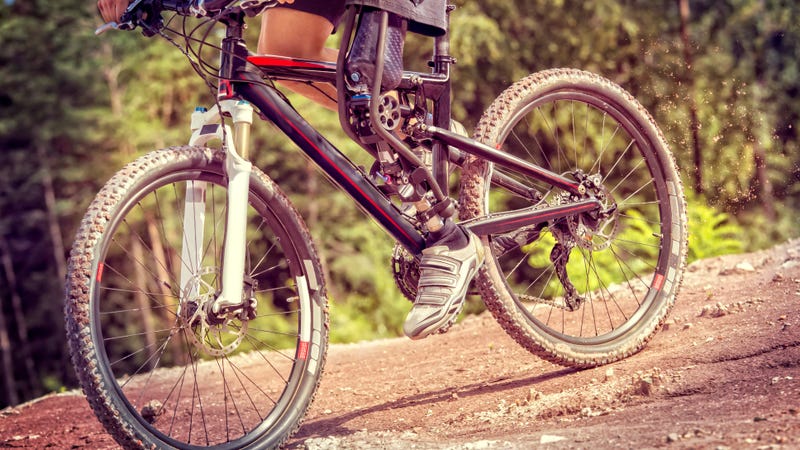 A person with a prosthesis riding a bike.