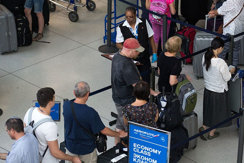 A Transportation Security Administration employee checks passenger tickets