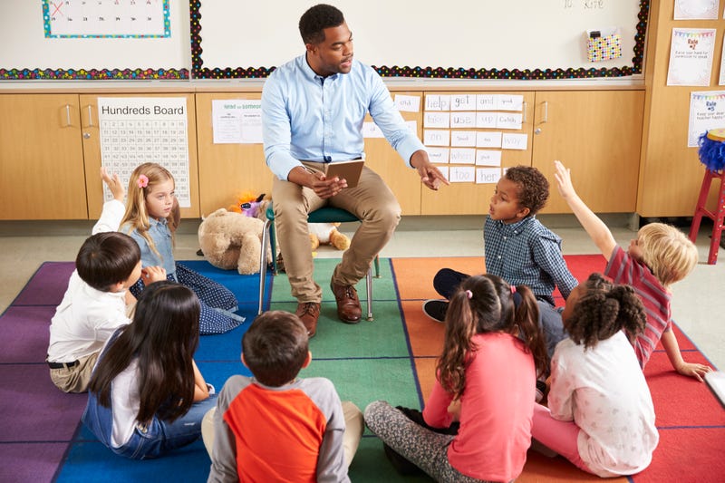 Students with teacher in classroom - Stock photo