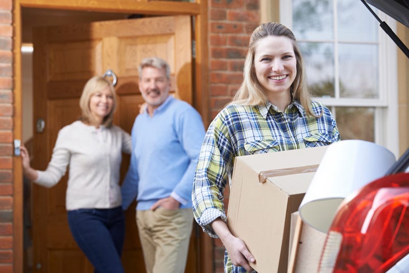 parents look on as daughter packs for college