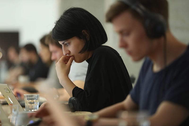 People work at computers in the community space of Factory Berlin on July 14, 2016 in Berlin, Germany.