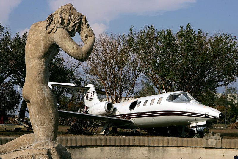  A private jet is seen near a statue in a fountain at the New Orleans Lakefront Airport September 17, 2005 in New Orleans, Louisiana.