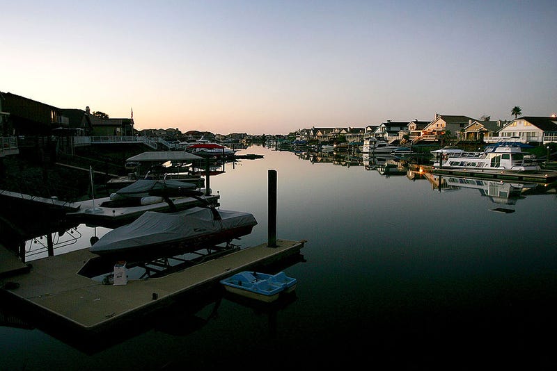 Night falls on a new development of large tract homes with docks and boats in the community of Discovery Bay, one of the residential islands surrounded by levees that hold back higher the waters of the Sacramento-San Joaquin River Delta, on September 28, 2005 west of Stockton, California.