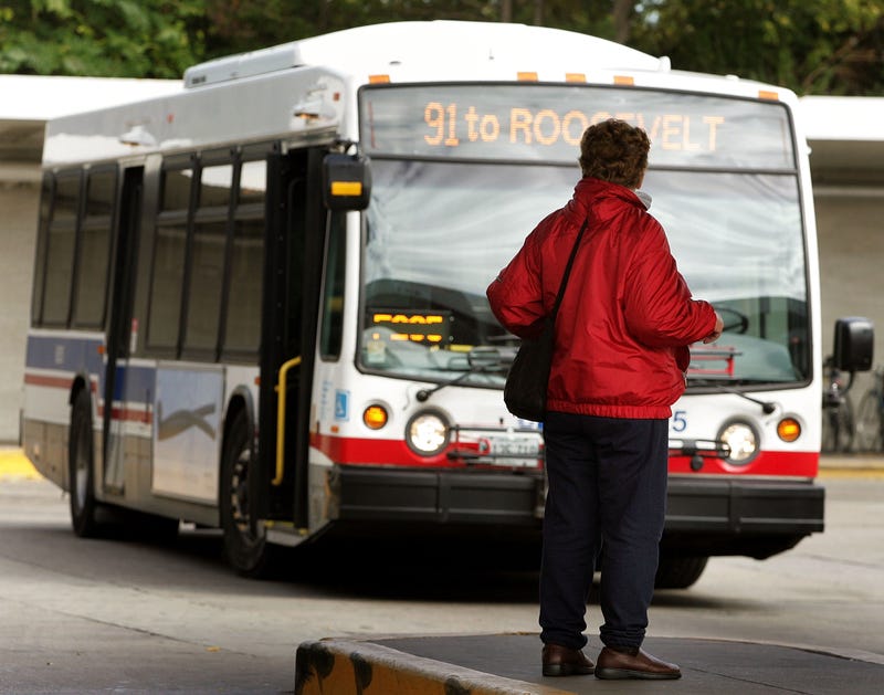 A public transportation rider awaits a bus at a Chicago Transit Authority (CTA) bus transit station October 21, 2005 in Chicago, Illinois.