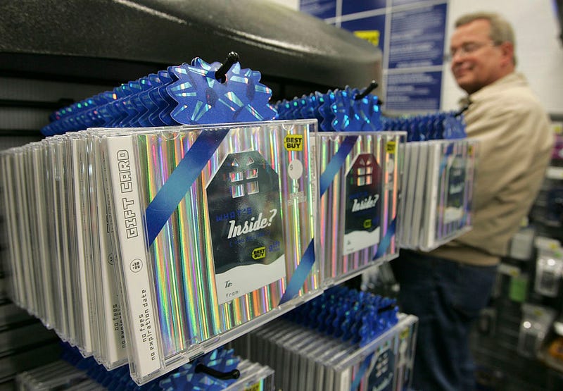 A customer looks at a display of Best Buy gift cards at a Best Buy store December 29, 2005 in San Francisco, California. Retailers experience a rise in gift card sales this holiday season and hope that customers will redeem them during post holiday sales since gift cards do not register as a sale until they are redeemed. (Photo by Justin Sullivan/Getty Images)