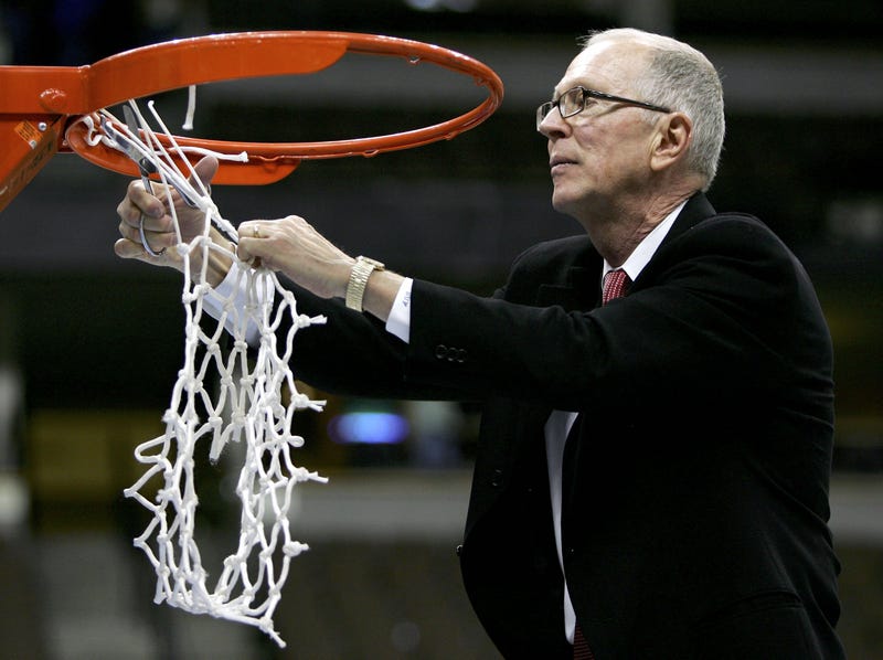 Head coach Steve Fisher of the San Diego State University Aztecs cuts down the net after defeating the Wyoming Cowboys 69-64 in the championship of the Mountain West Conference Basketball Tournament