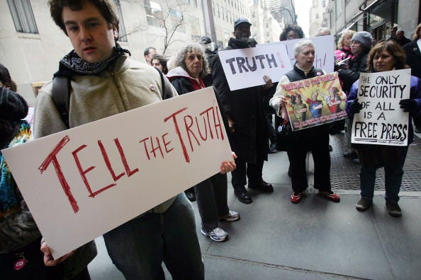 Antiwar protesters stand outside NBC headquarters to protest mainstream media's war coverage March 15, 2006 in New York City. 