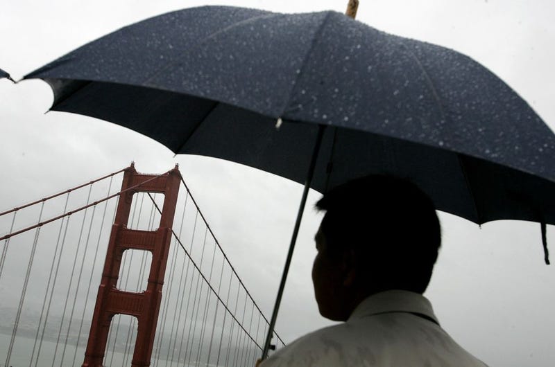 A man holds an umbrella as he views the north tower of the Golden Gate Bridge April 12, 2006 in Sausalito, California.