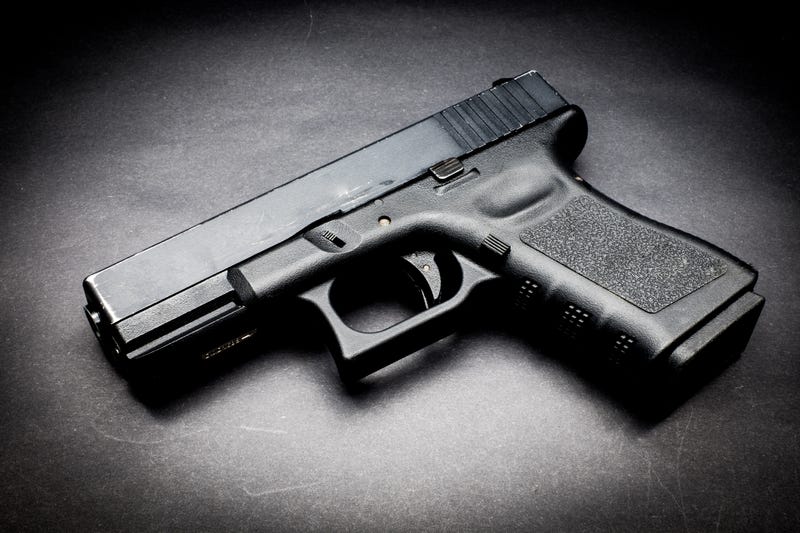 Hand gun on black background