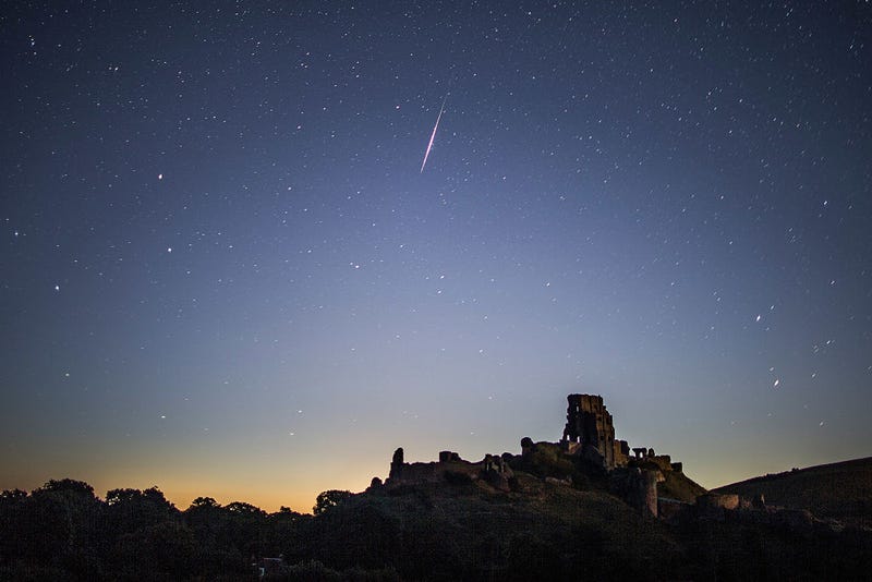 CORFE CASTLE, UNITED KINGDOM - AUGUST 12: A Perseid Meteor flashes across the night sky above Corfe Castle on August 12, 2016 in Corfe Castle, United Kingdom. The Perseids meteor shower occurs every year when the Earth passes through the cloud of debris left by Comet Swift-Tuttle, and appear to radiate from the constellation Perseus in the north eastern sky. 