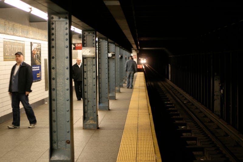 Passengers wait on the 28th street platform for the incoming train.