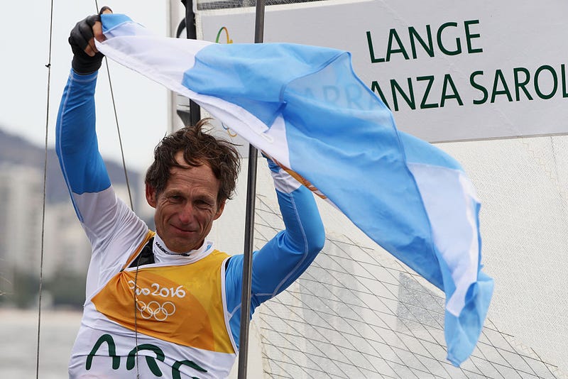 Santiago Lange of Argentina celebrates winning the gold medal in the Nacra 17 Mixed class on Day 11 of the Rio 2016 Olympic Games