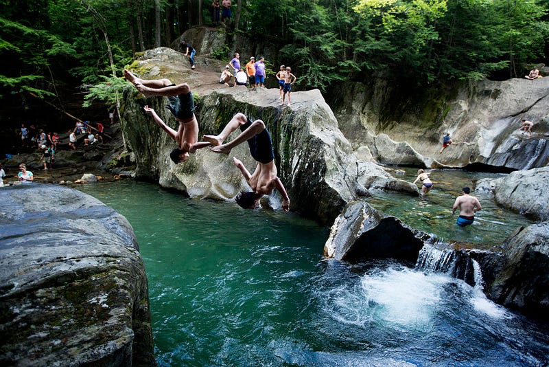 People swim at a swimming hole at Warren Falls, made up of a series of small, cascading waterfalls in Warren, Vt. on July 30, 2016.