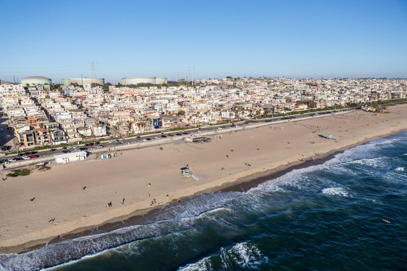 Afternoon aerial view of broad sandy beaches and layers of housing in Manhattan Beach, near Los Angeles, California.