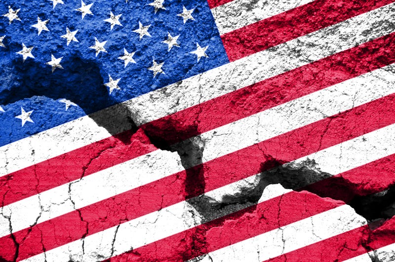 An American flag cracked on the ground.