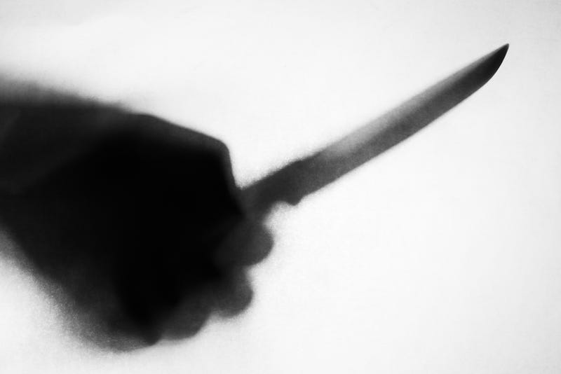Hand holding knife stock photo.
