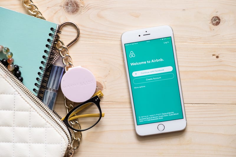 iphone with airbnb app on screen