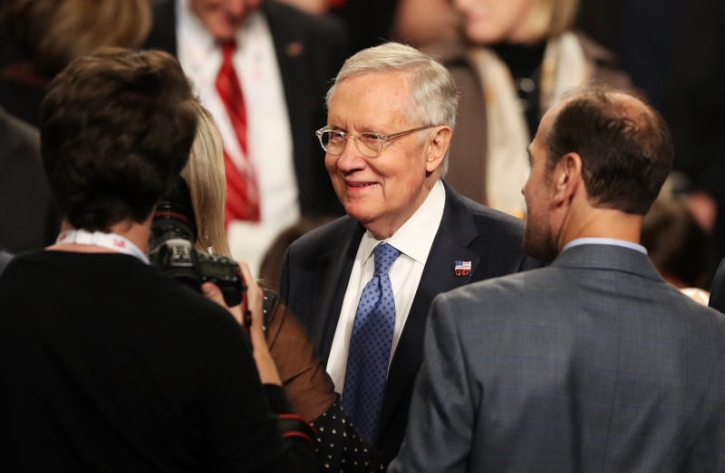 U.S. Senate Minority Leader Sen. Harry Reid (D-NV) speaks with guests before the start of the third U.S. presidential debate at the Thomas & Mack Center on October 19, 2016 in Las Vegas