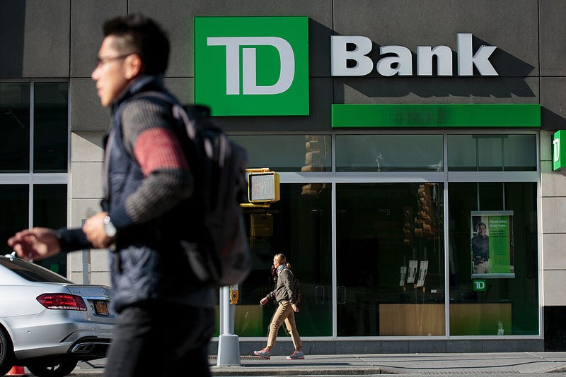 People walk past a TD Bank, October 24, 2016 in the Brooklyn borough of New York City. 