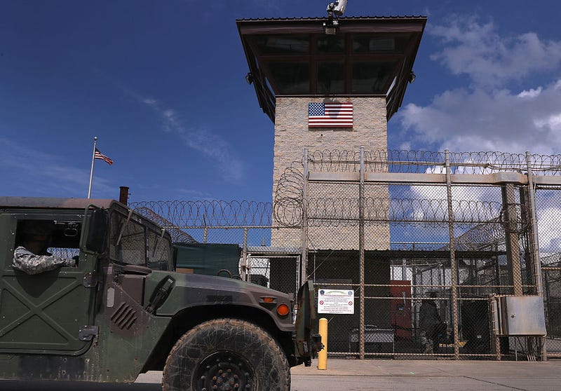 A humvee passes the guard tower guard tower at the entrance of the U.S. prison at Guantanamo Bay, also known as "Gitmo" on October 23, 2016 at the U.S. Naval Station at Guantanamo Bay, Cuba.