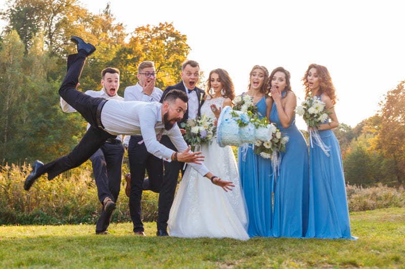 wedding party watching the cake fall to the floor