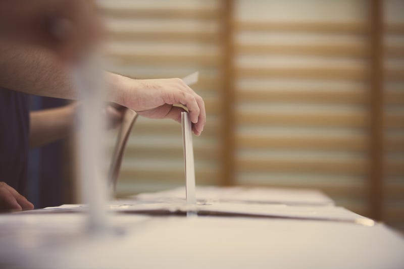 Person casting their ballot in an election.